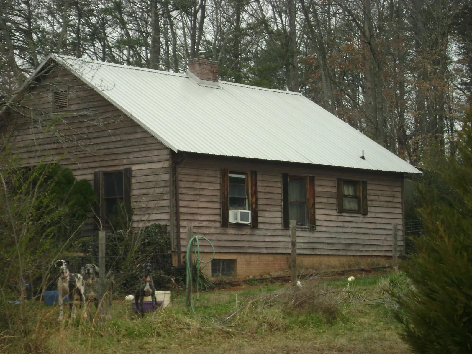 White metal roof on an old wood sided farmhouse, from a Metal Roof Installation job in Wyola